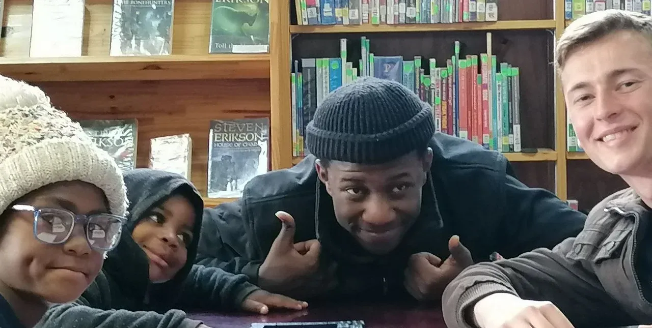 A young person surrounded by books